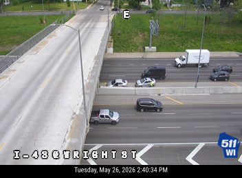 Emergency vehicles and personnel on the highway shoulder.