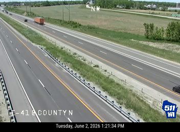 Emergency responders and vehicles are present on the highway, causing traffic backup.