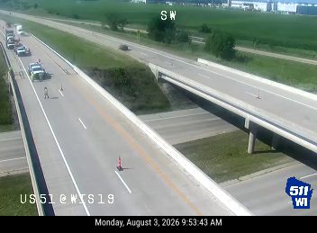 Construction cones and workers in the left lane