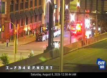 Multiple emergency vehicles with red and blue lights on the roadway