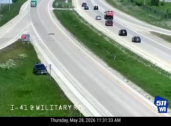 Police car on shoulder, possibly responding to an incident.