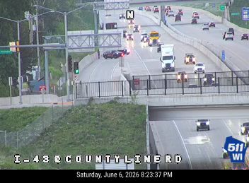 Two vehicles appear to be involved in a crash on the highway overpass.