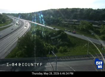 Emergency vehicles are visible on the side of the road, possibly responding to an incident.