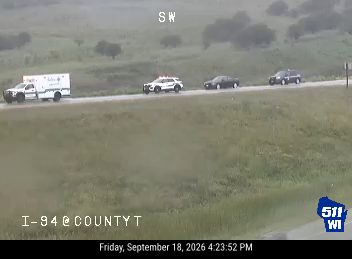Ambulance, police car, and another vehicle on the right shoulder