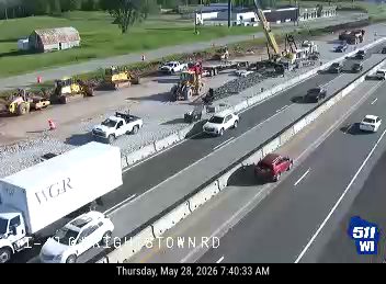 Construction zone with multiple vehicles and equipment, including a crane.