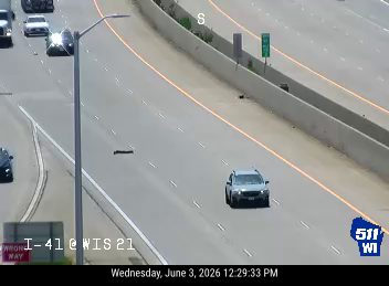A dark object, possibly debris, is on the roadway.