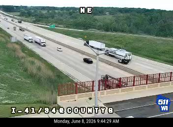 Emergency vehicle and equipment on the side of the highway, possibly responding to an incident.