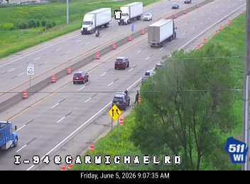 Police officer attending to a vehicle on the shoulder of I-94.