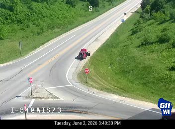 Red vehicle, possibly a fire truck, is stopped on the side of the road.