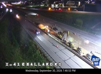 Construction equipment and workers in the right lane