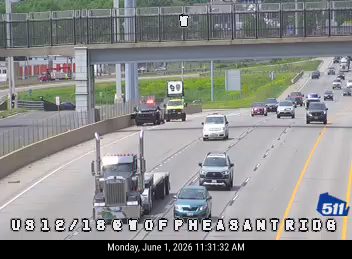 Police and emergency vehicles on the highway with traffic stopped.