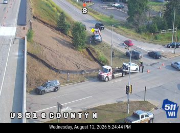 Tow truck assisting a vehicle on the right shoulder