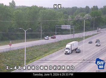 Emergency vehicles are stopped on the side of the highway, possibly responding to an incident.