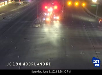 Emergency vehicles with flashing lights on the roadway at US18 @ Moorland Rd.