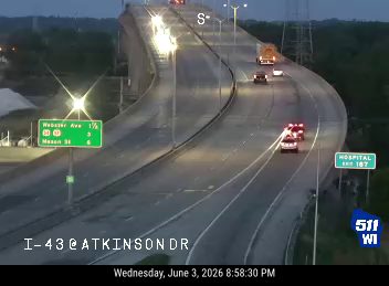 Emergency vehicles are present on the highway, indicating a possible incident.