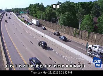 Emergency vehicles and a tow truck are stopped on the shoulder of the highway.