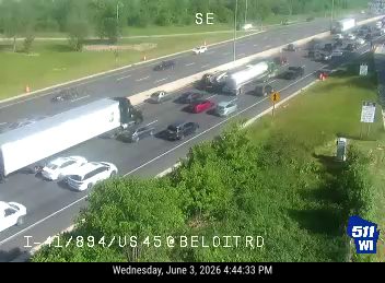 Multiple vehicles involved in a crash on the highway, blocking lanes.