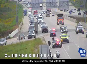 Police car with red and blue lights on the right shoulder