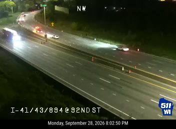 Two vehicles with hazard lights on in the right lane