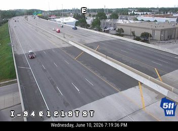 Emergency vehicle with lights on in the right lane of the highway.