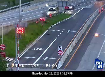 Emergency responders on the scene with flashing lights and cones on I-94 at Mitchell Blvd.