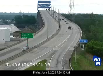 Tow truck and other vehicles stopped on the shoulder, possibly assisting with an incident.