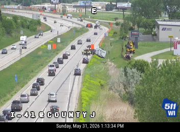 A white truck appears to have crashed on the right shoulder of the highway.