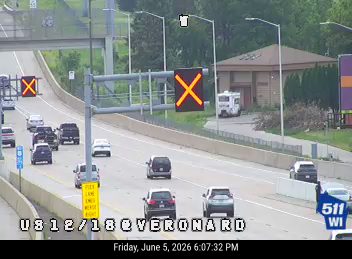 Emergency vehicle and personnel on roadside, traffic diverted.