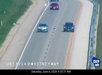 Police and other vehicles stopped on the highway, possibly responding to an incident.