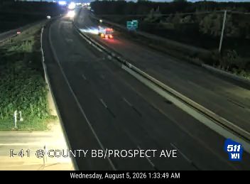 Fire truck with red and blue lights on the right shoulder
