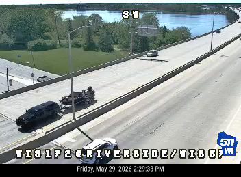 Road work with a truck and equipment on the right shoulder.
