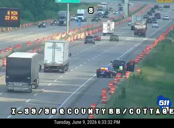 Two vehicles involved in a crash on the highway, blocking lanes.