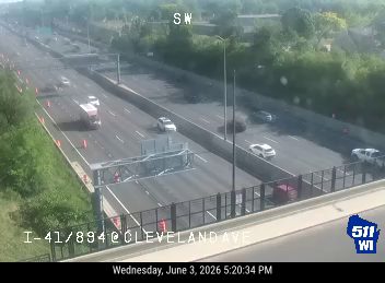 Debris on highway, traffic cones present, possible lane closure.