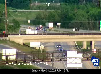 Emergency responders and vehicles are present on the roadway, indicating an incident.