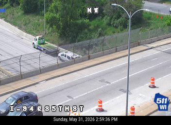 Tow truck and vehicles stopped on the shoulder, possibly assisting with an incident.