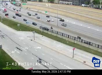 Emergency responders and vehicles on the highway shoulder.