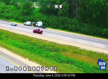 Emergency responders and vehicles are stopped on the shoulder of the highway.