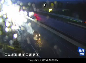 Vehicle appears to be crashed on the right shoulder with flashing lights.