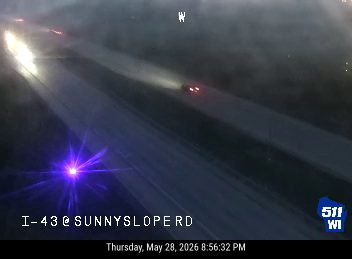 Emergency vehicle with flashing lights on I-43 at Sunnyslope Rd.