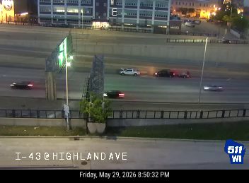 White pickup truck with hazard lights on, possibly a responder vehicle on the highway.