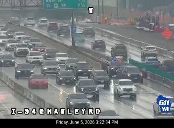 Police car with lights on in traffic, indicating a possible incident response.