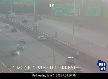 Emergency responders and vehicles on the right shoulder of the highway.