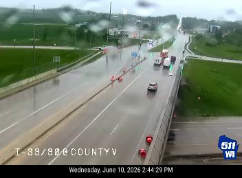 Emergency vehicles and cones on the roadway, likely responding to an incident.