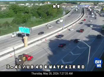 Vehicle overturned on highway, blocking traffic lanes.