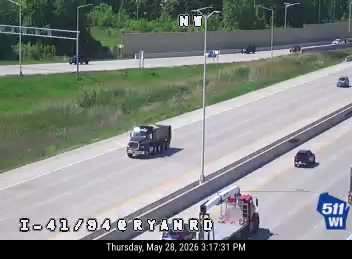 Fire truck and other vehicles on the side of the highway.
