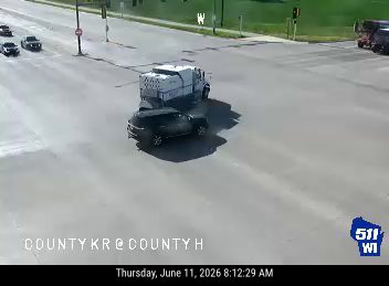 Car and truck appear to be involved in a collision at intersection.
