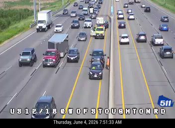 Emergency responder and vehicle on the shoulder of the highway.
