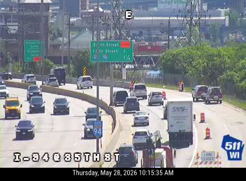 Emergency responders with cones and barriers on the right shoulder of I-94.