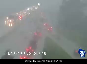 Traffic camera shows a multi-vehicle crash with emergency lights visible.
