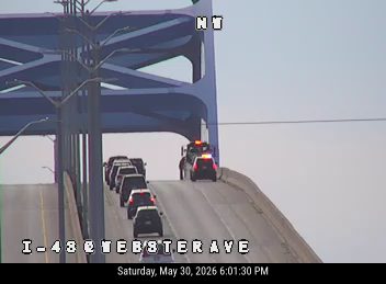Police vehicles responding to an incident on the highway overpass.